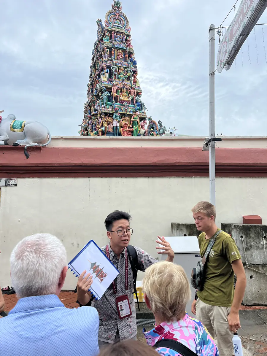 Adam storytelling to guests outdoors in Little India, Singapore